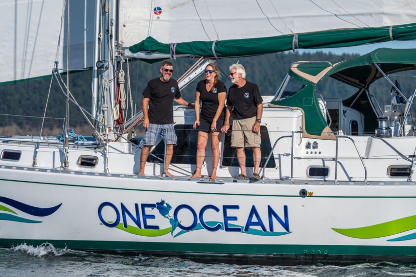 Three of the crew members standing on the vessel One Ocean, Mike Beemer, Jennifer Dalton, and Captain Mark Schrader