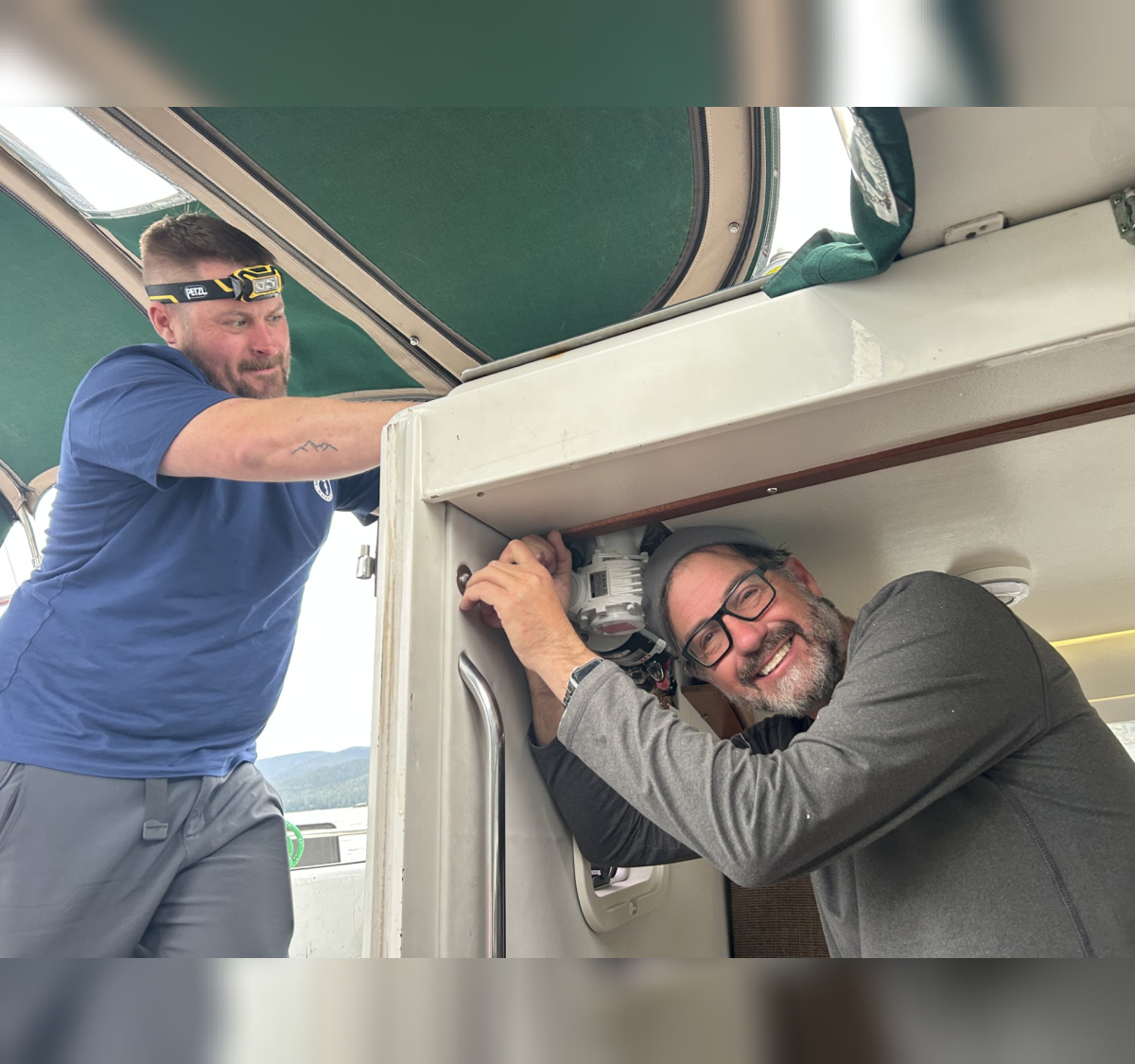 2 people working on electric winch