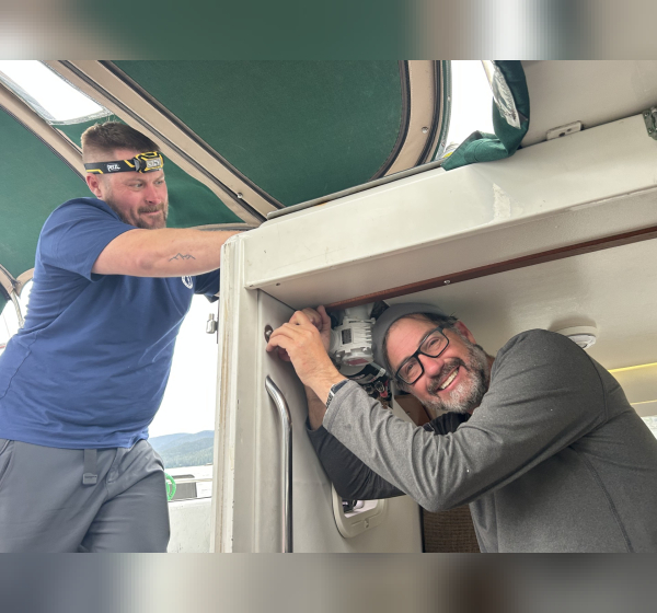 2 people working on electric winch