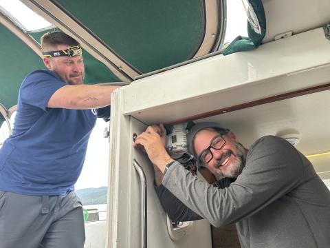 2 people working on electric winch